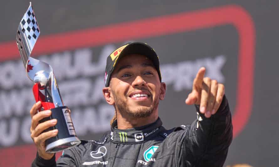 Lewis Hamilton celebrates on the podium by pointing towards his team or the fans after finishing third at the Circuit Gilles-Villeneuve.