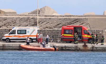 Italian coast guard command teams and firefighters taking part in the search for the yacht that sank off the coast of Porticello.