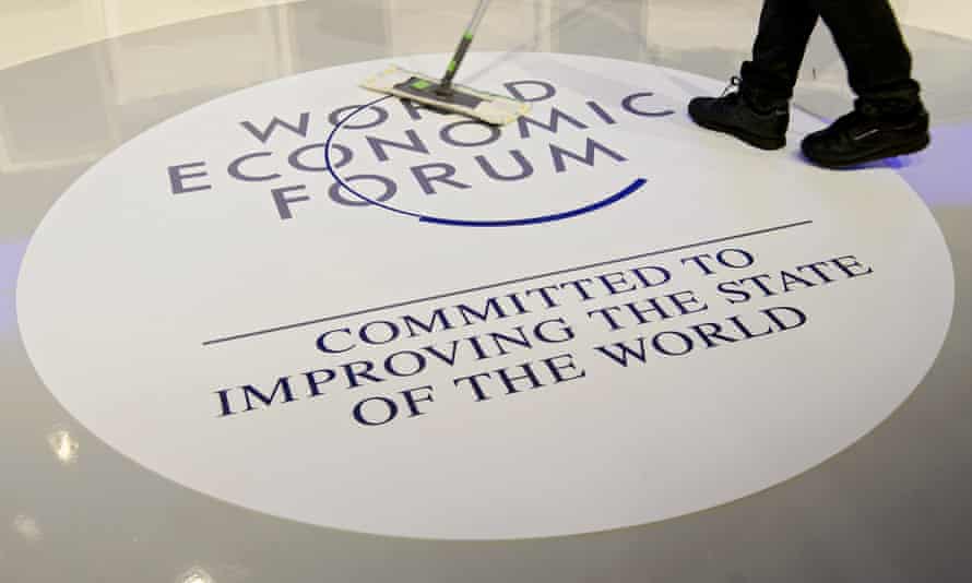 A worker cleans the WEF logo in Davos
