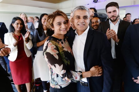 A smiling Saadiya and Sadiq Khan with people clapping in the background