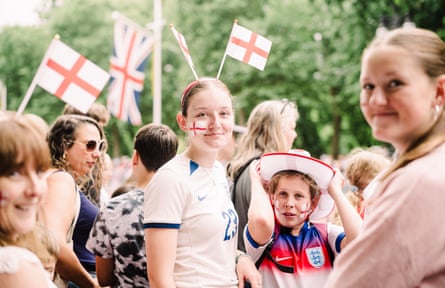 Young England fans, with flags painted on cheeks and flag headbands