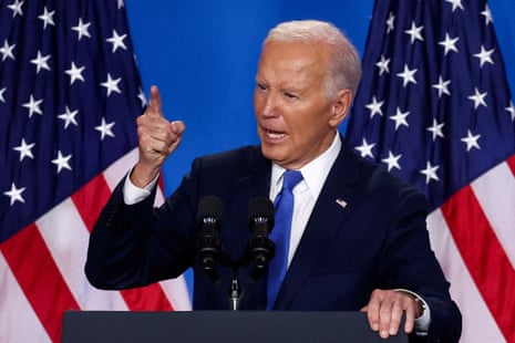 Biden in front of US flags.