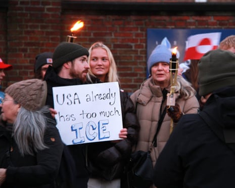 Protesters demonstrate against US plans on Greenland, with a man holding a sign that says 'USA already has too much ICE'