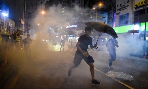 Protesters react after police fired tear gas in the Mong Kok district of Hong Kong.
