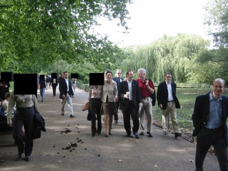 A smiling Clinton has his arm around Spacey. They walks next to Maxwell amid an entourage