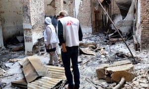 MSF staff stand in their destroyed hospital in Kunduz.