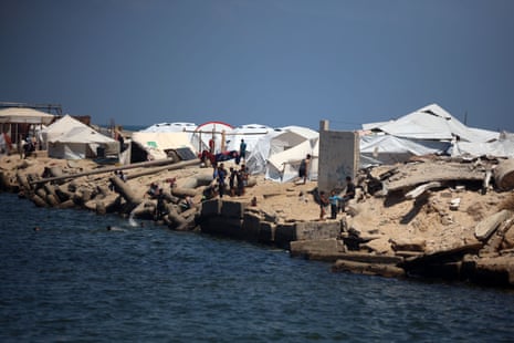 Tents are set up for displaced Palestinians along the beach near the port in Gaza City.
