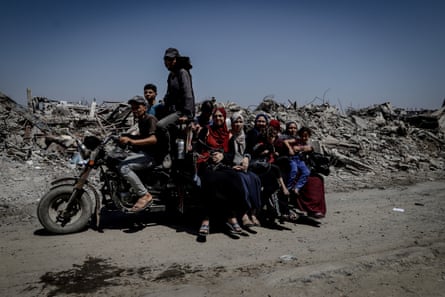 A group of people sit on a vehicle