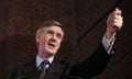 Sir Jacob Rees-Mogg holding an arm aloft while giving a speech in February 2024