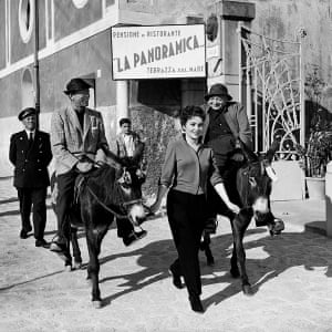 Gina Lollobrigida leads two donkeys carrying actors Humphrey Bogart and Peter Lorre along a street in Ravello, Italy on 30 March 1953, while taking a break from filming Beat the Devil