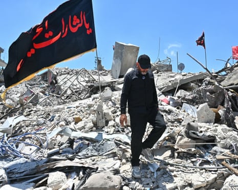 A resident walks on Wednesday through the rubble of homes and businesses destroyed by the Israeli military in the southern Lebanese village of Bir al-Salasil.