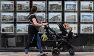 Woman walking past estate agency
