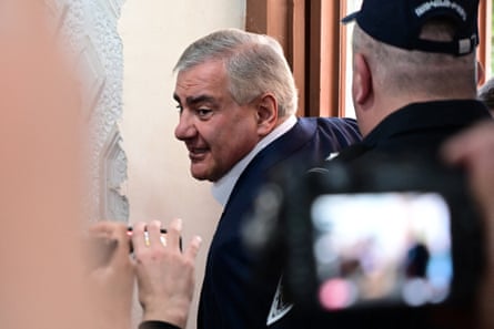 Samvel Karapetyan turns to look behind him as he walks into the polling station
