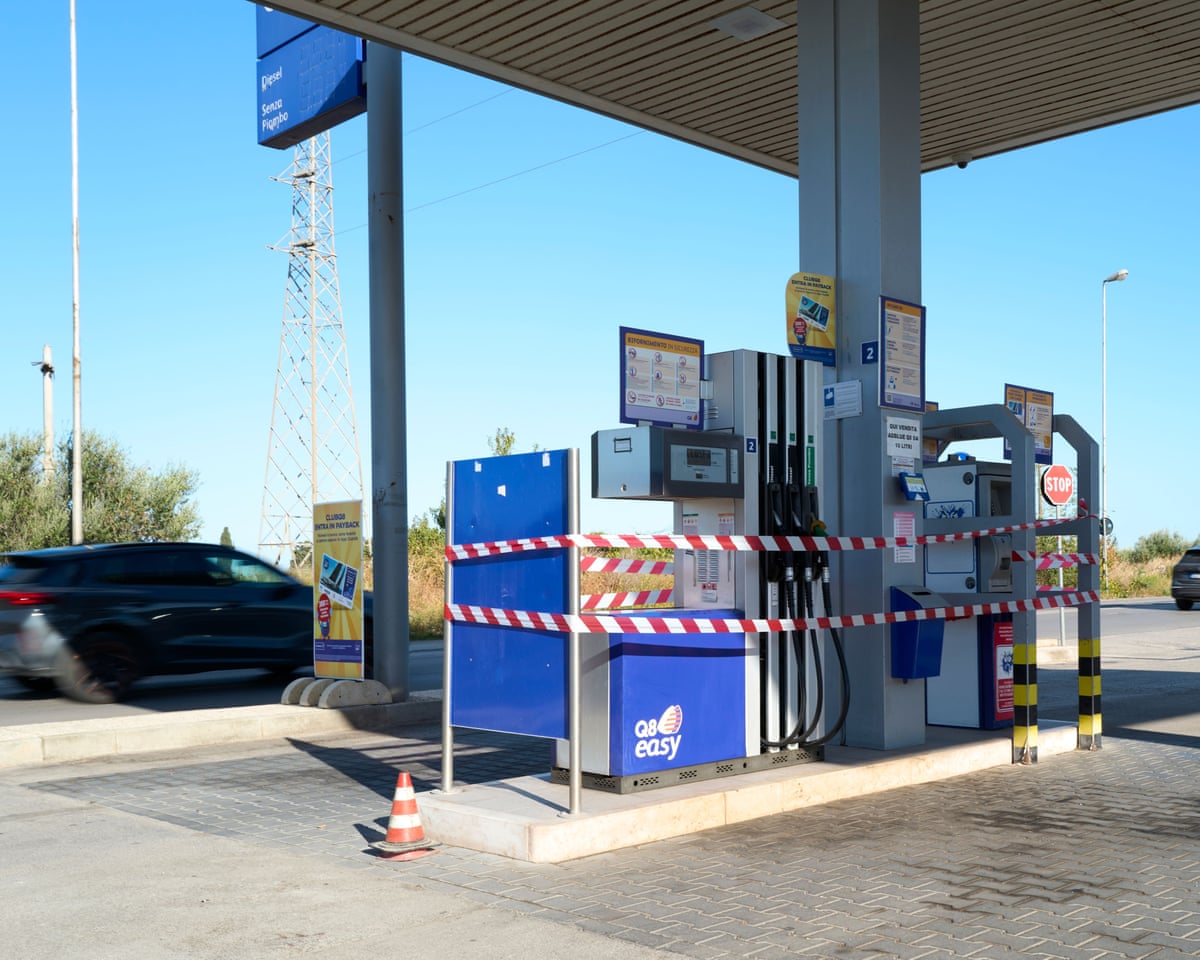Fuel pumps in Barletta, Italy are wrapped in red and white barrier tape amid a fuel shortage
