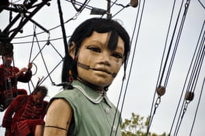 Puppeteers manipulate Little Girl Giant. The puppet was produced by French outdoor arts event company Royal de Luxe and has previously been paraded in Liverpool, UK.