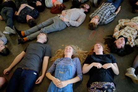 Participants lie on the floor during a ‘laughter workshop’ led by experimental musician Laraaji, at Cafe Oto in Dalston, London.