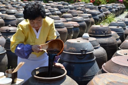 Ki Soon-do checks the colour and aroma of her ganjang (soy sauce), assessing its development through sensory evaluation developed over decades of experience. "You just know when the flavour won't develop further."