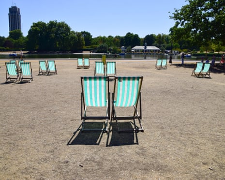 Empty deck chairs sit in the scorching sun in a completely dry Hyde Park, London which is normally covered in green grass as drought conditions continue.