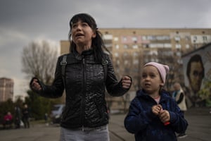 Julia, 34, cries next to her daughter Veronika, 6, while talking to a group of journalists in Brovary, on the outskirts of Kyiv.