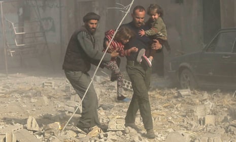 Syrians run with their children after an Assad-ordered air strike in Ghouta, Damascus.