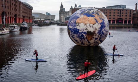 People paddle around Luke Jerram's Floating Earth art installation in Albert Dock as part of the Eurovision celebrations in Liverpool.