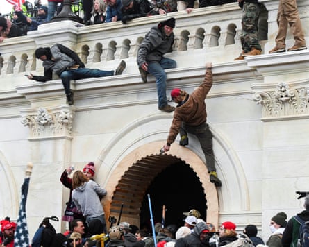 People scaling wall