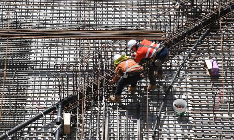 Construction workers are seen working at the Roma Street Station on the Cross River Rail project in Brisbane