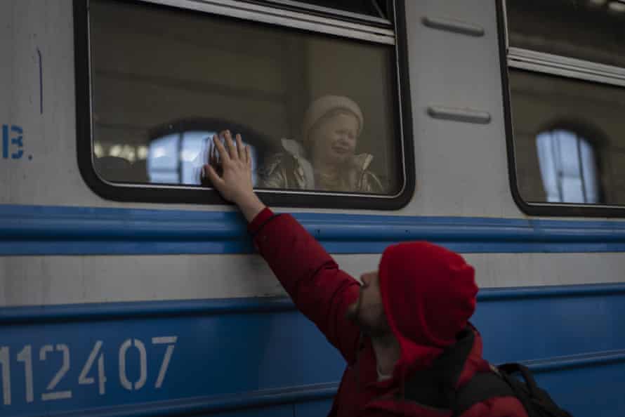 Displaced Ukrainians on a Poland-bound train bid farewell in Lviv, western Ukraine