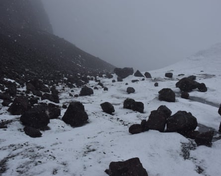 A snowy landscape strewn with boulders
