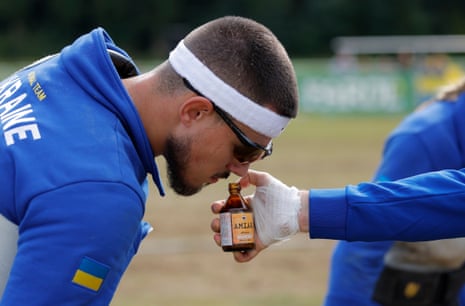 A member of Ukraine’s 520kg junior mixed team takes a sniff of smelling salts.