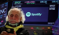 A screen displays trading information for Spotify as a trader works on the floor at the New York Stock Exchange on 4 December.