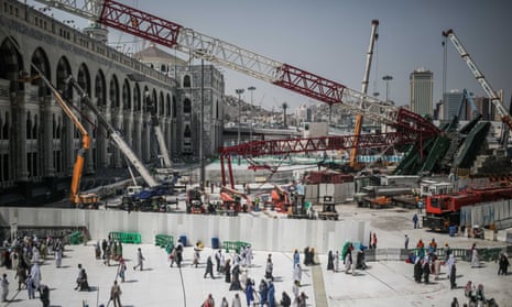 Muslim pilgrims walk past a collapsed crane that killed more than 100 people at the Grand Mosque in Mecca, Saudi Arabia.
