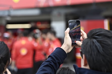 A man uses his smartphone to take a photo in Suzuka, Japan.