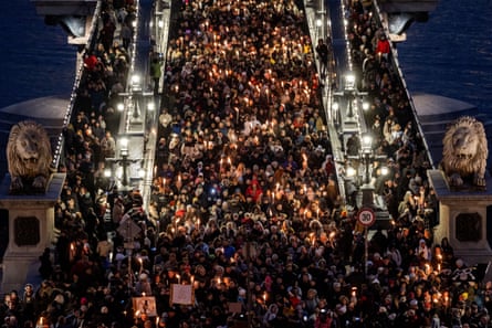Protesters with torches fill the Chain Bridge in Budapest