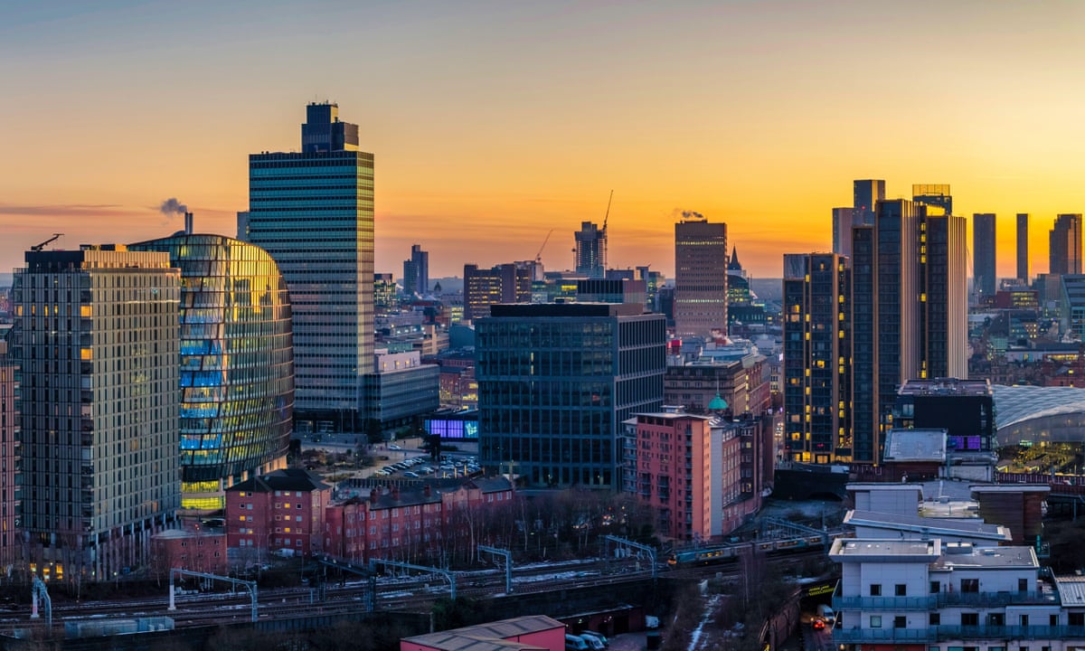 Manchester skyline blending industrial heritage and modern buildings at sunset