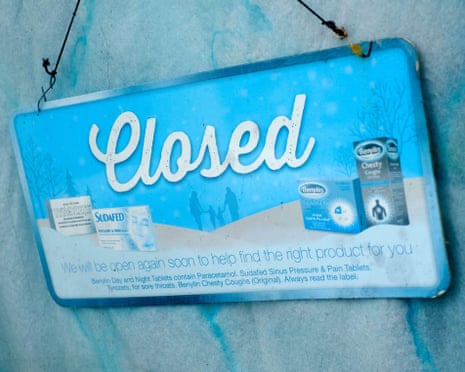 A closed sign on a pharmacy door
