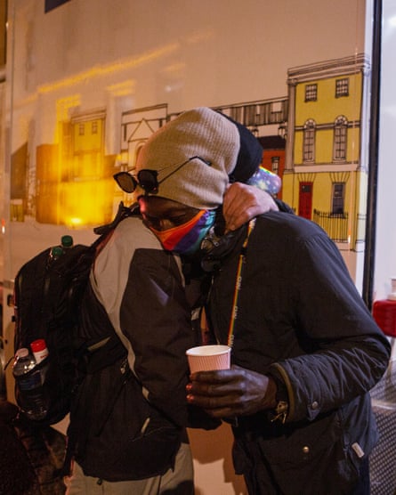 Ousainou Sarr is kissed by a Romanian man seeking health care on the street