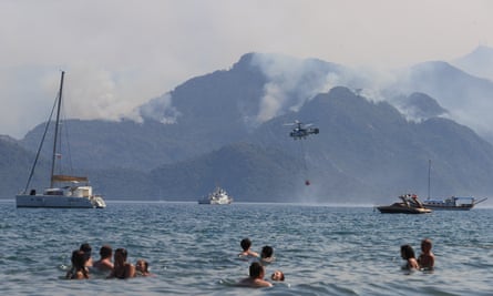 A helicopter responds to the forest fire that broke out in Marmaris district in Mugla, Turkey.