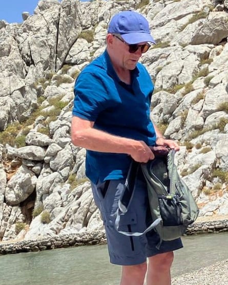 Michael Mosley pictured on a beach in blue shorts, shirt and cap