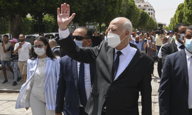 Kais Saied waves to bystanders as he strolls along the avenue Bourguiba in Tunis on 1 August.