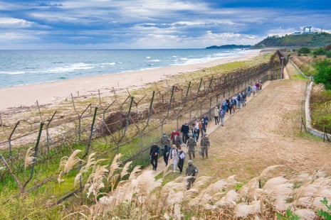 Beachside section of a DMZ peace trail in Goseong, South Korea, lined with barbed wire. It is a restricted zone requiring a military escort.