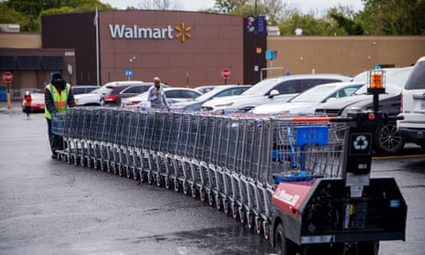 A Walmart employee collects shopping carts in Alexandria, Virginia. 