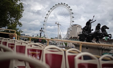 A near-empty top deck on a London open-top tour as it passes the London Eye