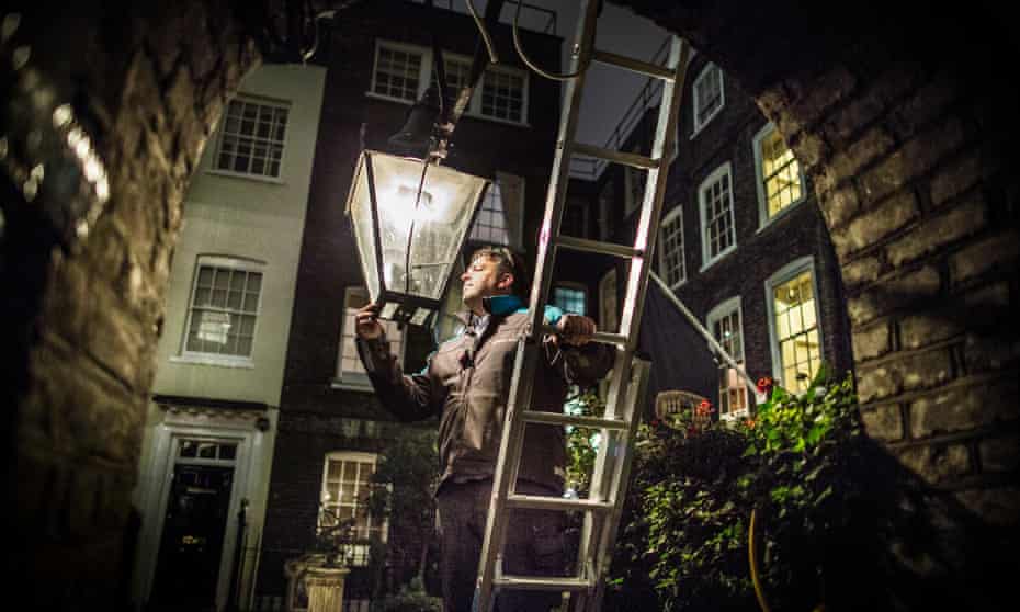 Garry Usher checks a gas lamp in Pickering Place, Mayfair