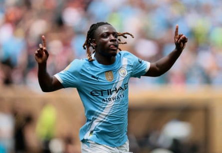 Jérémy Doku celebrates scoring.