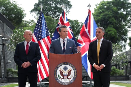 Richard Marles and British defence secretary John Healey look on as US secretary of defense Pete Hegseth speaks in Singapore