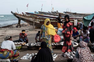 Shoppers buy fish at Tanji market in October 2018