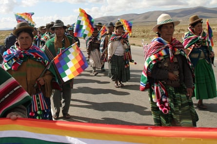 Aymara and Quechua peasants march by the road which links the cities of Cochabamba and La Paz