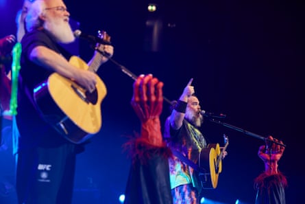 two men with guitars performing