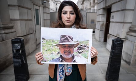 Roxanne Tahbaz holds a picture of her father, Morad Tahbaz, who is jailed in Iran, protests outside the Foreign, Commonwealth and Development Office (FCDO).